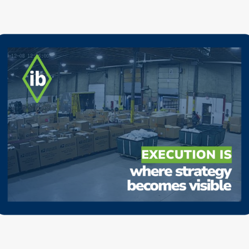 Warehouse operations with shipping containers and text “Execution is where strategy becomes visible,” illustrating operational performance in logistics.