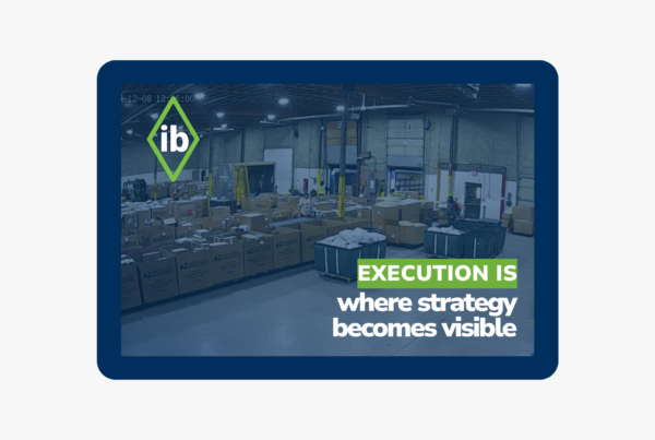 Warehouse operations with shipping containers and text “Execution is where strategy becomes visible,” illustrating operational performance in logistics.